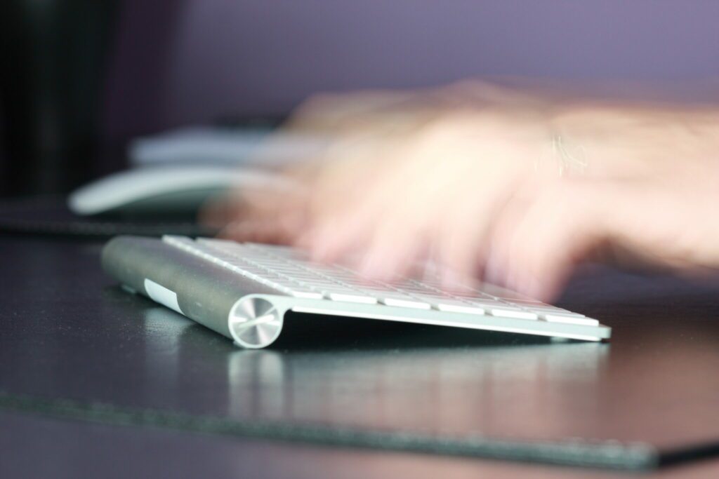 Hands typing on keyboard stock
