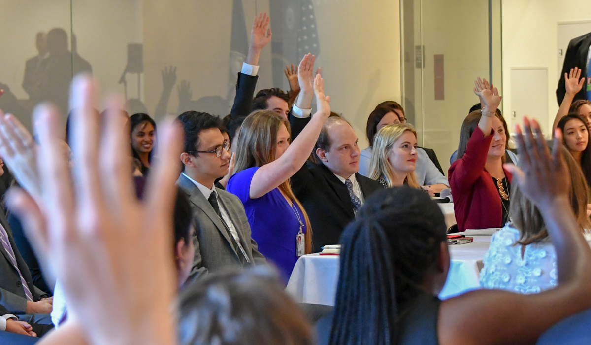 Benefits of Internships A room full of audience members raising their hands.